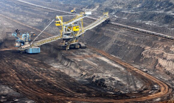View into a coal mine with working wheel excavator