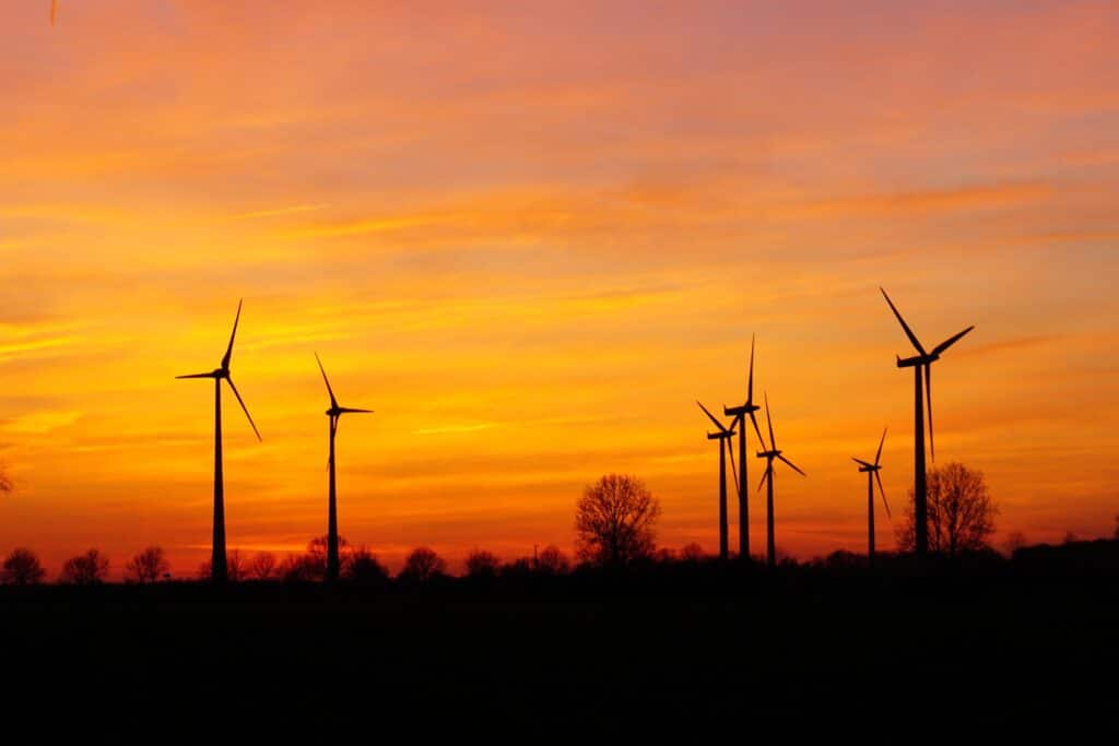 Wind turbines over a sunset